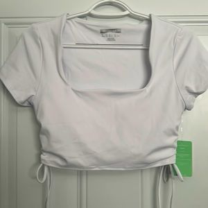 NEVER WORN Medium white fun top! Padding included in shirt. Still has tags!